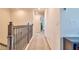 Upstairs hallway with carpet and wrought iron railing at 20472 Monza Loop, Land O Lakes, FL 34638