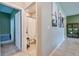 Hallway view showing bathroom and an adjacent room with neutral walls and tile flooring offering a calm living space at 20472 Monza Loop, Land O Lakes, FL 34638