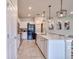 Modern kitchen featuring white cabinetry, stainless steel appliances, an island, and ample counter space at 20472 Monza Loop, Land O Lakes, FL 34638