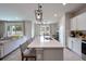 Spacious kitchen island with seating, pendant lighting, and modern appliances, perfect for entertaining at 20472 Monza Loop, Land O Lakes, FL 34638