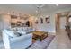 Inviting living room showcasing a comfortable sofa, stylish decor, and an open layout to the kitchen at 20472 Monza Loop, Land O Lakes, FL 34638