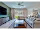 Spacious living room with comfortable seating, a large coffee table, and a view of the backyard at 20472 Monza Loop, Land O Lakes, FL 34638