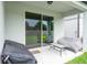 Covered patio with outdoor furniture, offering a serene and comfortable space for relaxation and entertainment at 20472 Monza Loop, Land O Lakes, FL 34638