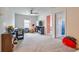 Spacious playroom with carpet, TV, ceiling fan, and view to the Bedroom at 20472 Monza Loop, Land O Lakes, FL 34638