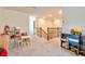 Upstairs playroom with carpet, table and chairs, and shelves full of toys at 20472 Monza Loop, Land O Lakes, FL 34638