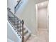Carpeted staircase featuring wrought iron railing at 20472 Monza Loop, Land O Lakes, FL 34638