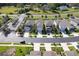 Aerial view of modern homes lining a street, highlighting landscaping, driveways, and neighborhood layout at 20472 Monza Loop, Land O Lakes, FL 34638