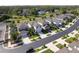 Aerial view of a quiet street featuring modern houses with well-kept lawns and landscaping at 20472 Monza Loop, Land O Lakes, FL 34638