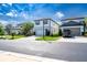 Attractive street view featuring modern homes with neatly kept lawns and a black pickup truck parked in the driveway at 20472 Monza Loop, Land O Lakes, FL 34638