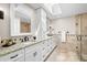 Bathroom features dual sinks, granite countertops, and a glass-enclosed shower for a spa-like experience at 2057 Kansas Ne Ave, St Petersburg, FL 33703