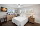 Bright bedroom with hard floors, natural light from the shuttered windows, and tasteful, coastal-inspired decor at 2057 Kansas Ne Ave, St Petersburg, FL 33703