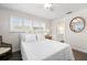 Bright bedroom featuring hardwood floors, natural light, and a door leading to an ensuite bathroom at 2057 Kansas Ne Ave, St Petersburg, FL 33703
