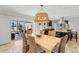 Bright dining room with statement lighting fixture and views of the pool and patio through sliding glass doors at 2057 Kansas Ne Ave, St Petersburg, FL 33703