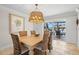 Dining area with wicker furniture and an elegant light fixture, offering views of the pool area at 2057 Kansas Ne Ave, St Petersburg, FL 33703
