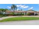 Charming one-story home featuring a red tile roof, manicured landscaping, and a brick driveway at 2057 Kansas Ne Ave, St Petersburg, FL 33703