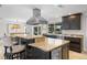 Gourmet kitchen features granite countertops, stainless steel appliances, and a center island with seating at 2057 Kansas Ne Ave, St Petersburg, FL 33703
