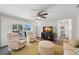 Comfortable living room features plush seating, a ceiling fan, and sliding glass doors to the outdoor space at 2057 Kansas Ne Ave, St Petersburg, FL 33703