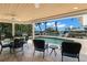 Outdoor pool area featuring a covered patio with a ceiling fan and serene waterfront views at 2057 Kansas Ne Ave, St Petersburg, FL 33703