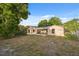 Wide backyard featuring a screened in porch and patio at 2141 Brent Pl, Palm Harbor, FL 34683