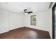 Spacious bedroom features a modern ceiling fan, wood-look floors and a closet with white doors at 2141 Brent Pl, Palm Harbor, FL 34683