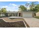 Inviting home featuring manicured landscaping and an attached two-car garage at 2141 Brent Pl, Palm Harbor, FL 34683