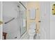 Bright bathroom features a walk-in shower with safety bar, toilet, and towel rack at 235 Woodridge Cir, Oldsmar, FL 34677