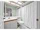 Cozy bathroom with a shower and tub combination featuring a neutral color scheme and vanity at 235 Woodridge Cir, Oldsmar, FL 34677