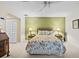 A calm bedroom features a ceiling fan, and two bedside lamps at 235 Woodridge Cir, Oldsmar, FL 34677