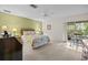 The bedroom features a ceiling fan and a sliding door to the outside at 235 Woodridge Cir, Oldsmar, FL 34677
