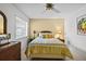 Comfortable bedroom with ceiling fan, sunny window, and charming decor at 235 Woodridge Cir, Oldsmar, FL 34677