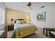 Bedroom with ceiling fan and sunny window featuring charming decor at 235 Woodridge Cir, Oldsmar, FL 34677