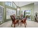 Bright dining space with high windows, chandelier, and sliding glass doors to outdoors at 235 Woodridge Cir, Oldsmar, FL 34677