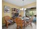 Cozy dining nook with bright, airy feel, featuring a glass table and comfortable seating at 235 Woodridge Cir, Oldsmar, FL 34677
