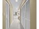 Hallway featuring closet space and an adjoining bathroom with bathtub and sink at 235 Woodridge Cir, Oldsmar, FL 34677