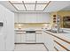Bright kitchen featuring white cabinetry, modern appliances, and ample counter space at 235 Woodridge Cir, Oldsmar, FL 34677
