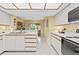 Bright kitchen featuring white cabinetry, modern appliances, and an eat-in breakfast nook at 235 Woodridge Cir, Oldsmar, FL 34677