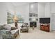 Inviting living area with a fireplace, and comfortable chairs, offering a cozy atmosphere at 235 Woodridge Cir, Oldsmar, FL 34677
