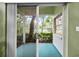 Enclosed patio offers views of the lush backyard, seamlessly blending indoor/outdoor living at 235 Woodridge Cir, Oldsmar, FL 34677