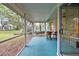 Screened patio with serene views of landscaped yard, offers a peaceful retreat for relaxation at 235 Woodridge Cir, Oldsmar, FL 34677