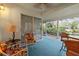 Tranquil screened patio featuring comfortable seating and picturesque views of the surrounding greenery at 235 Woodridge Cir, Oldsmar, FL 34677
