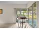 Sunroom with sliding glass doors, an exterior view, and a tall work table with seating at 235 Woodridge Cir, Oldsmar, FL 34677