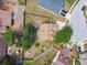 Aerial view of the property showcasing the fenced backyard, mature trees, and neighborhood at 24231 Satinwood Ct, Lutz, FL 33559