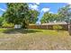 Expansive backyard enclosed by a wood fence, featuring ample space for outdoor activities and relaxation at 24231 Satinwood Ct, Lutz, FL 33559