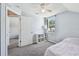 Cozy bedroom with gray carpet, ceiling fan and natural light from the window with modern shelving at 24231 Satinwood Ct, Lutz, FL 33559