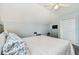 Cozy bedroom featuring light walls, ceiling fan, and a comfortable bed with floral pattern pillows at 24231 Satinwood Ct, Lutz, FL 33559