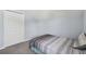 Spare bedroom featuring gray carpeting, a double closet and neutral wall paint at 24231 Satinwood Ct, Lutz, FL 33559
