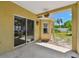 Covered patio with sliding glass door access showcases an inviting outdoor living space with a view of the backyard at 24231 Satinwood Ct, Lutz, FL 33559