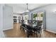 Open dining area with kitchen view, modern table setting, and sliding glass doors to patio at 24231 Satinwood Ct, Lutz, FL 33559