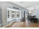 Dining area with wood floors, a bay window, and sliding door access to the backyard at 24231 Satinwood Ct, Lutz, FL 33559