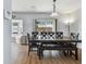 Dining room with a modern table, stylish lighting, and a bay window with a seating area at 24231 Satinwood Ct, Lutz, FL 33559